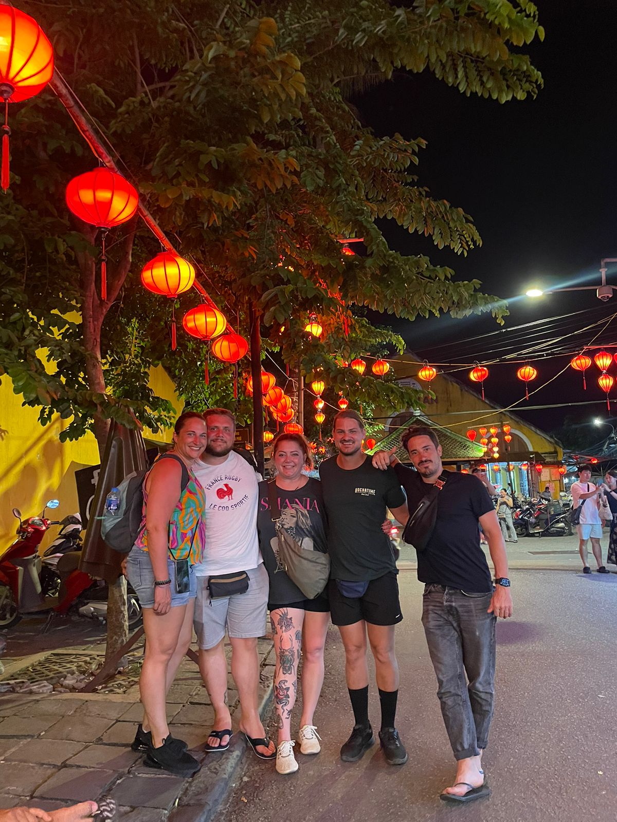Happy tour group under red lanterns in Hoi An Ancient Town